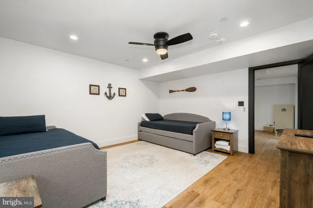 a bedroom with furniture and a wooden floor