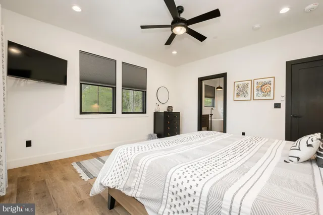 a bedroom with a bed and a large window