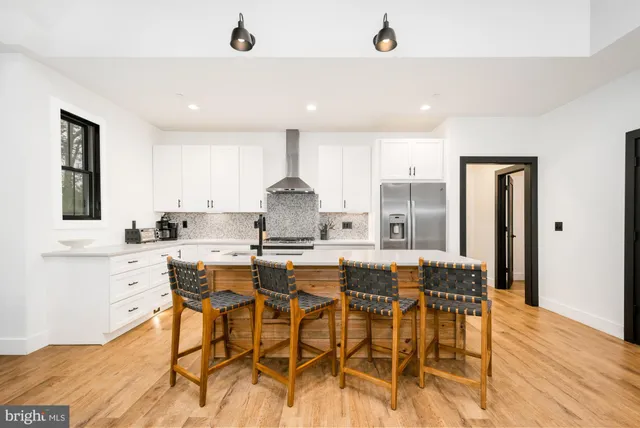 a kitchen with stainless steel appliances kitchen island granite countertop a sink and cabinets