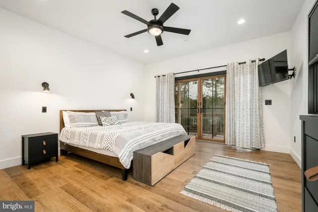 a bedroom with a large bed and a large window