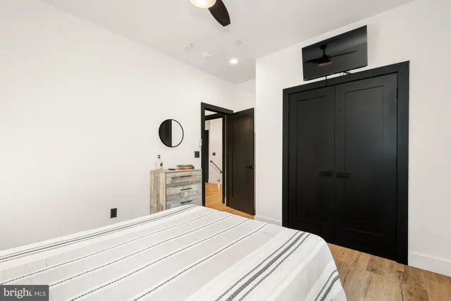 a bedroom with a bed and a painting on the wall