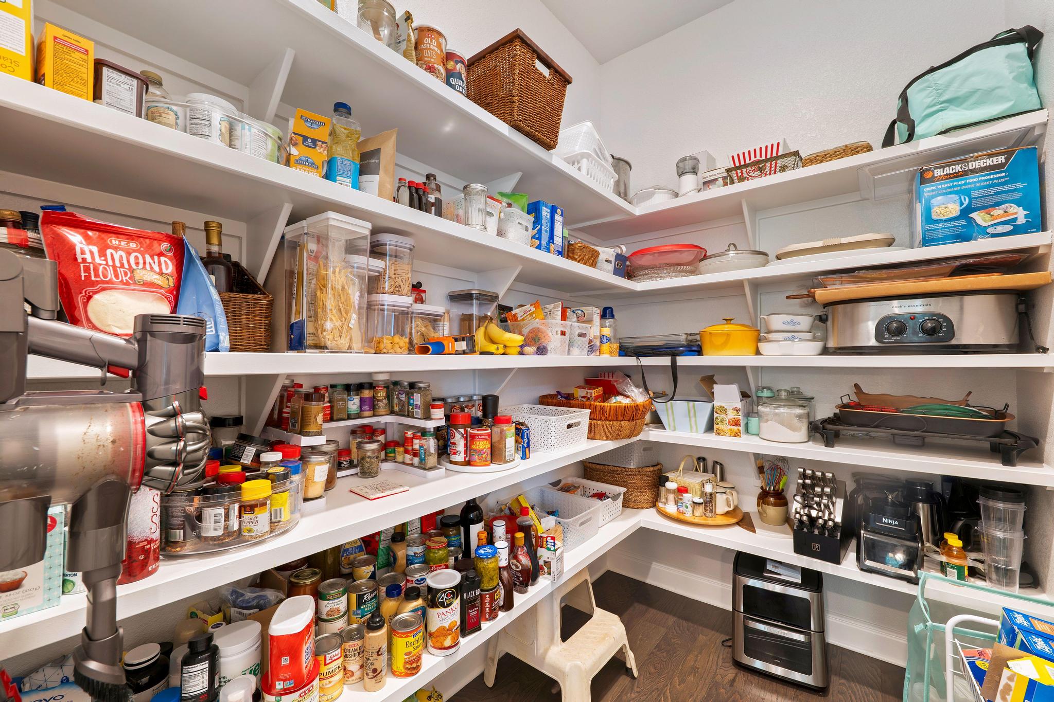 1009 Legacy Crossing Georgetown, TX 78628 - Photo 18 of 40 Well-organized shelving provides abundant storage for culinary essentials and small appliances.