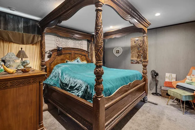 a bed sitting in a room next to a window