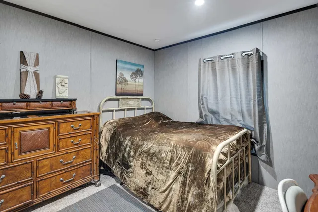 a bedroom with a bed and with furniture