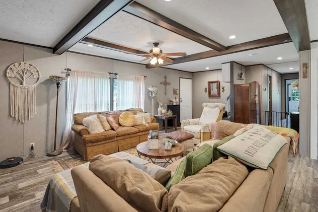a living room with furniture ceiling fan and a rug