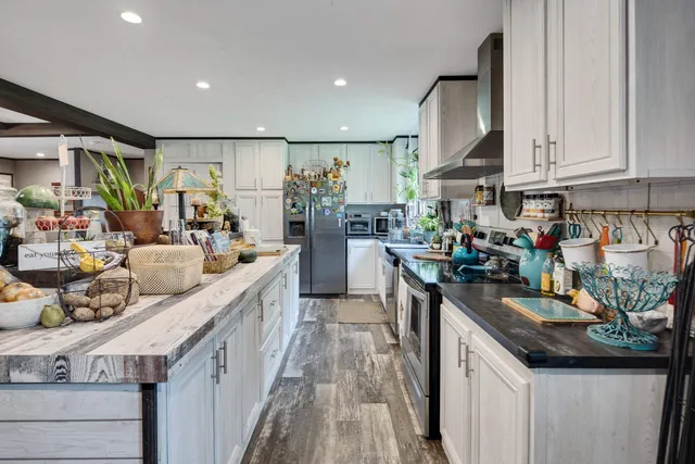 a kitchen with counter top space a sink stove and cabinets