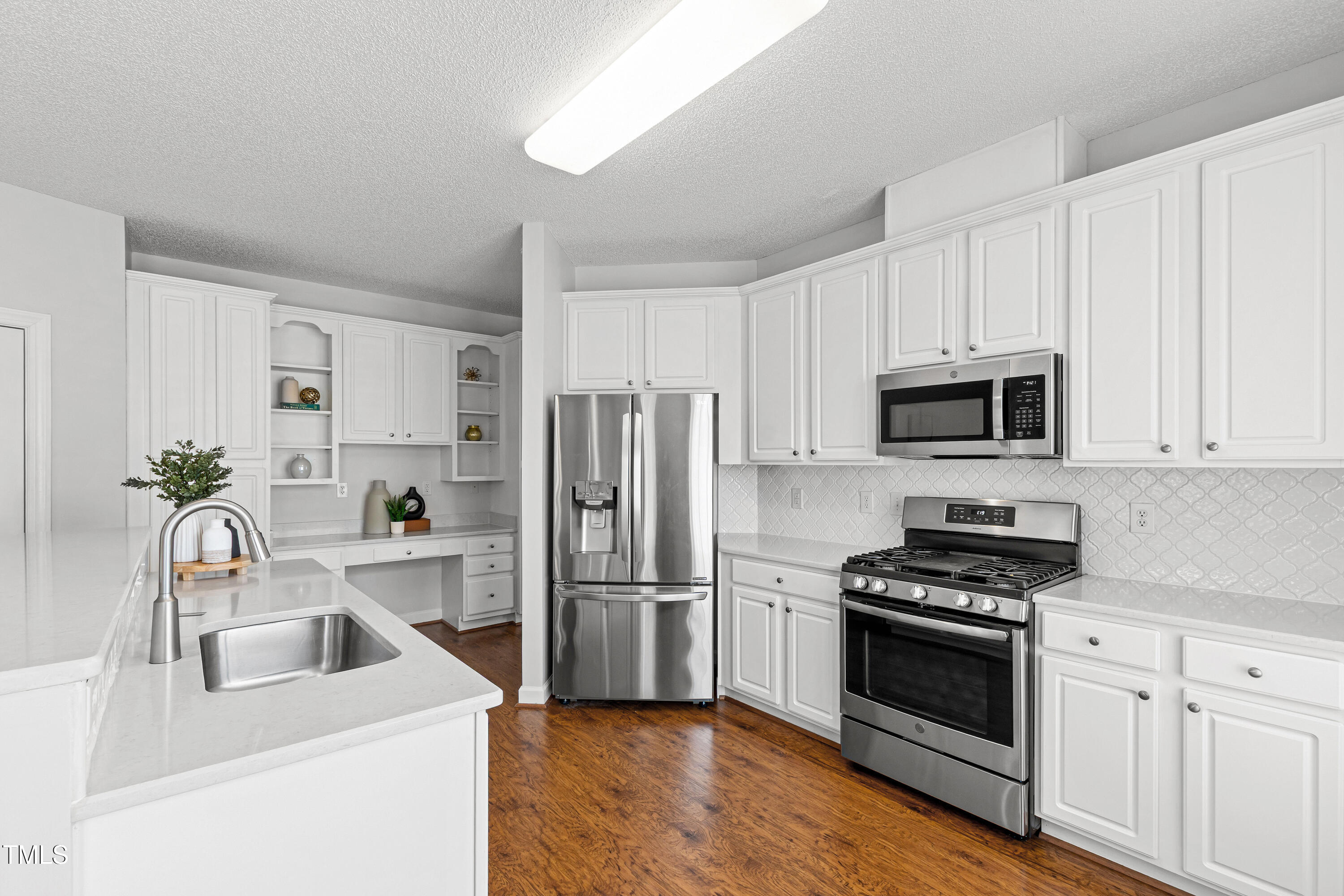 2024 Heritage Pines Drive Cary, NC 27519 - Photo 11 of 31 a kitchen with granite countertop a sink appliances and cabinets