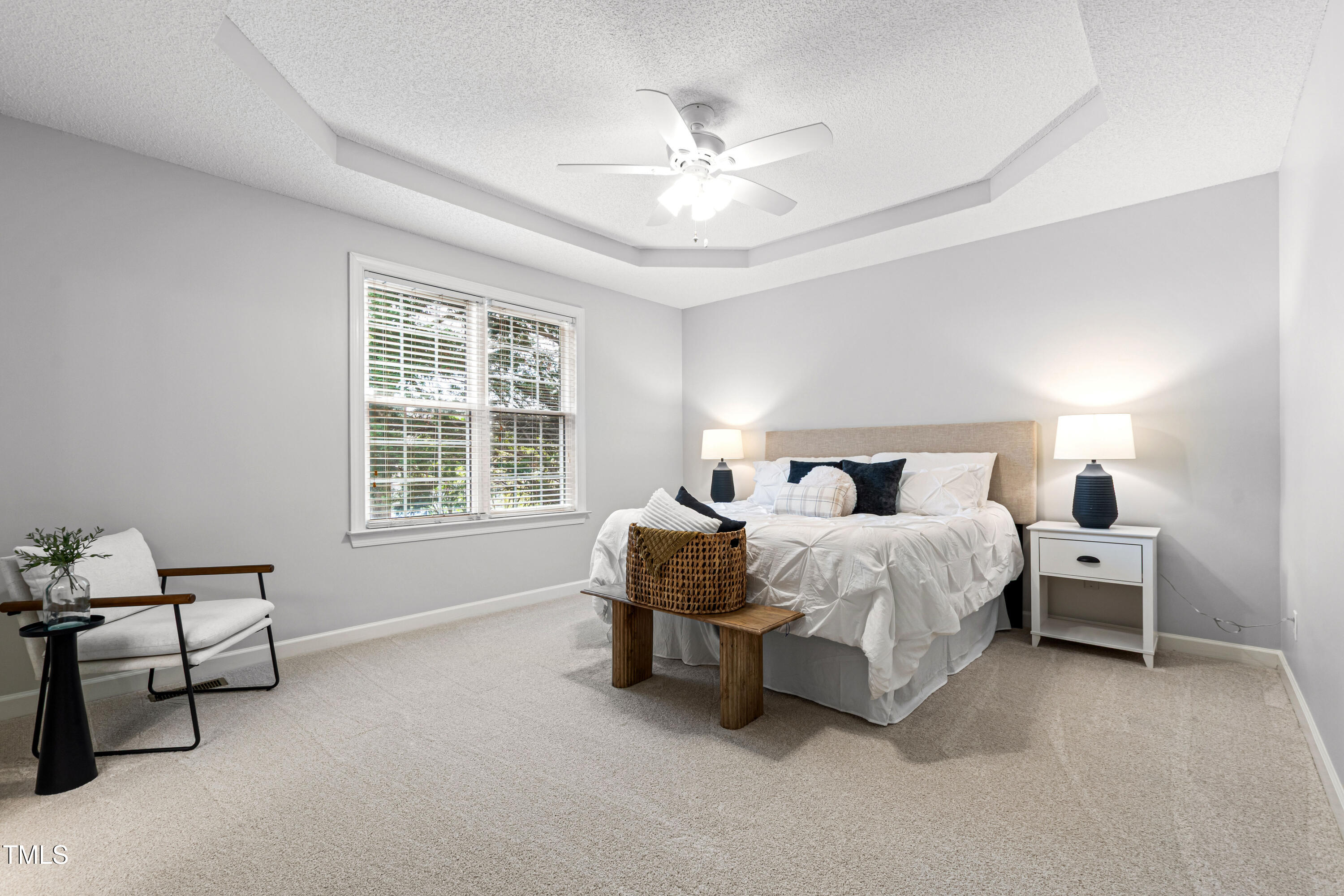 2024 Heritage Pines Drive Cary, NC 27519 - Photo 20 of 31 a bed room with a bed and a chandelier