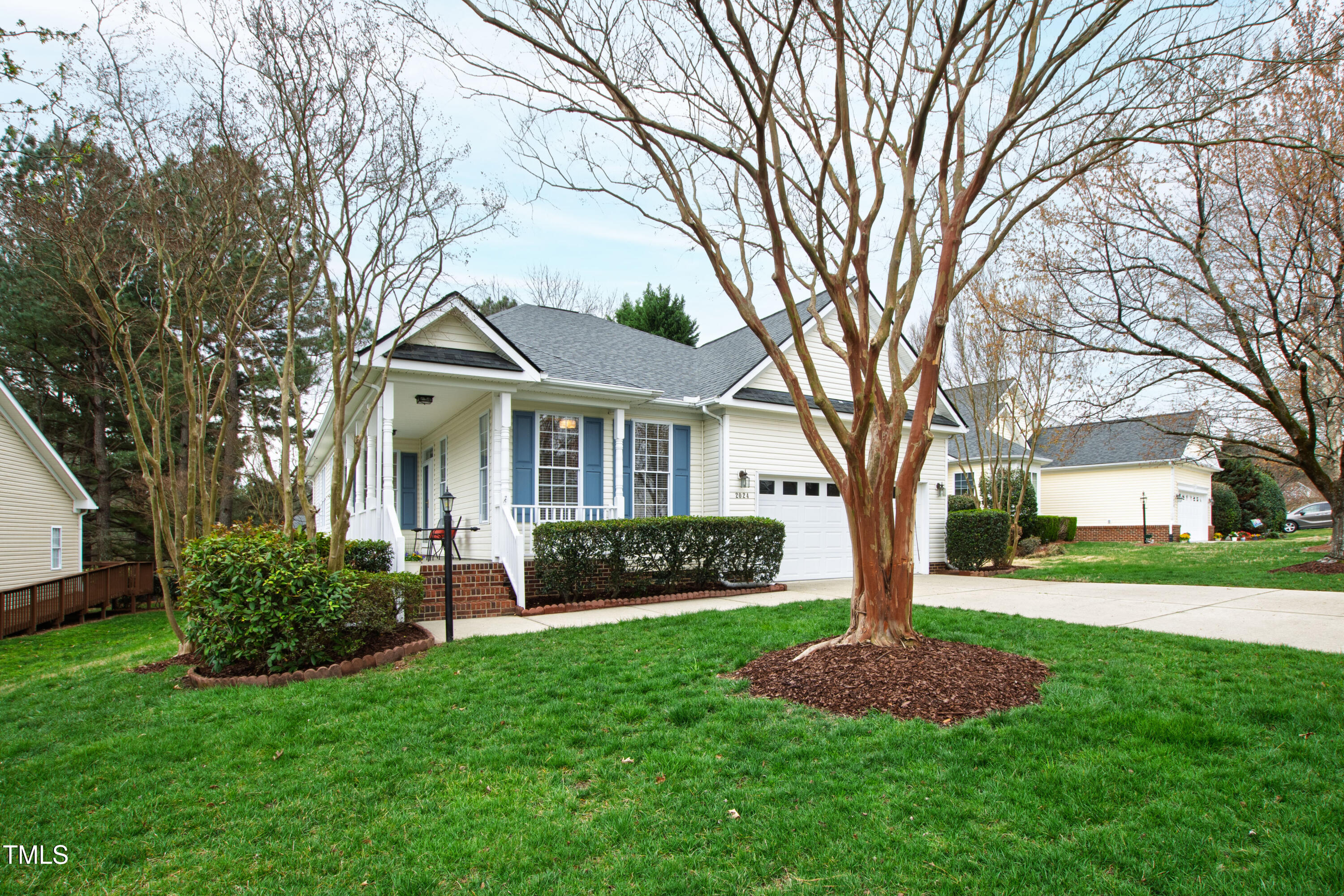 2024 Heritage Pines Drive Cary, NC 27519 - Photo 2 of 31 a front view of a house with a garden and trees