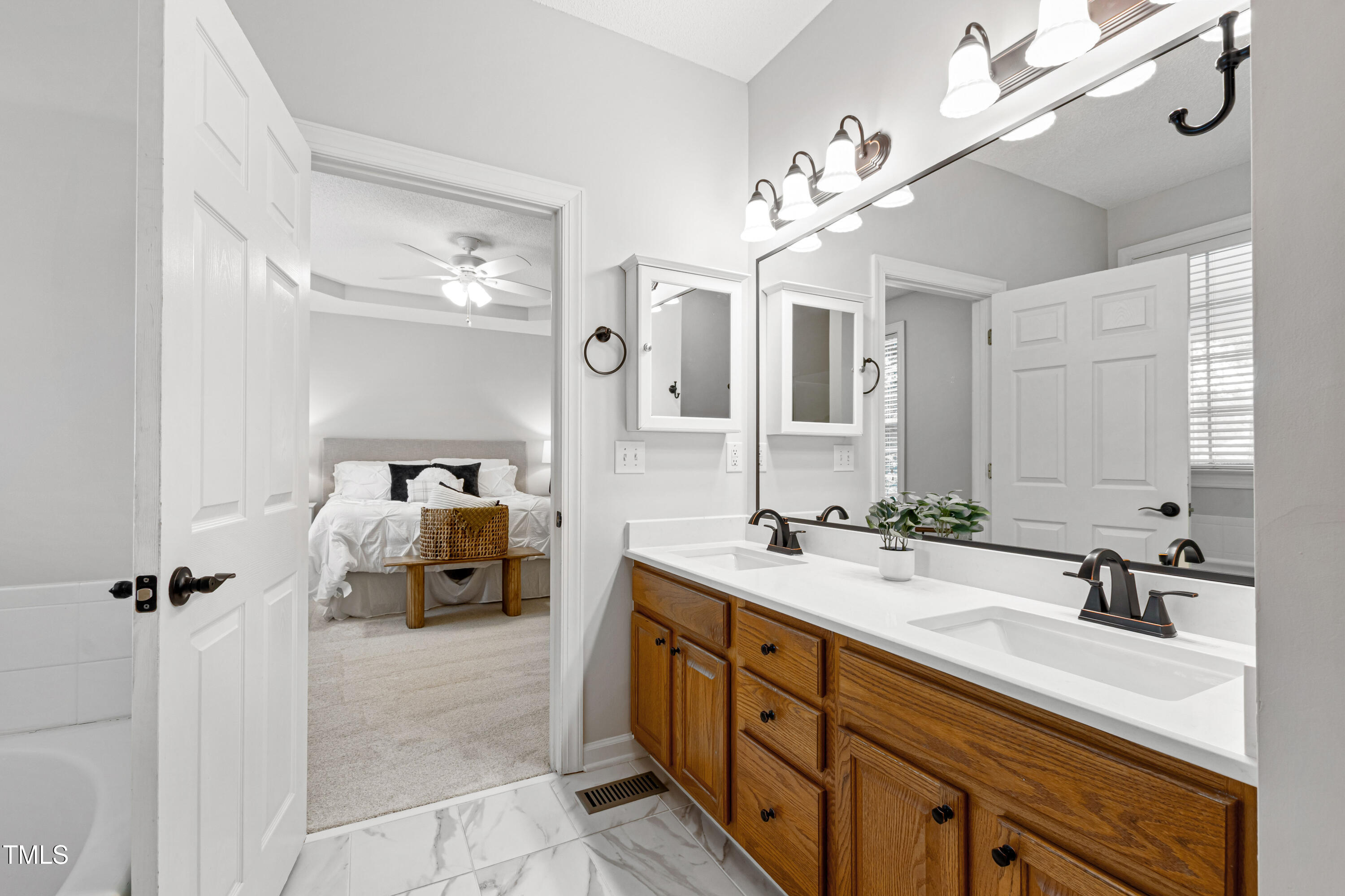 2024 Heritage Pines Drive Cary, NC 27519 - Photo 21 of 31 a spacious bathroom with a double vanity sink a mirror and shower