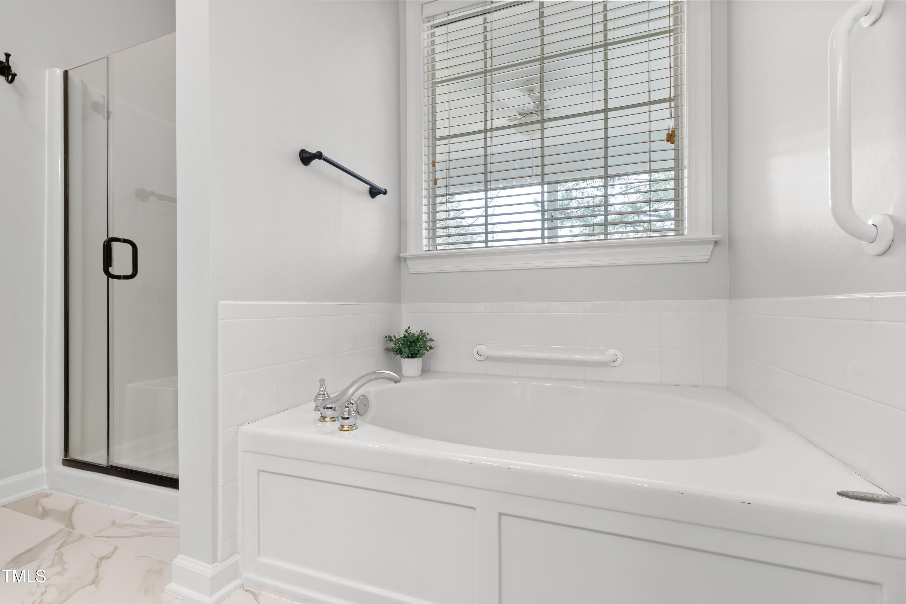 2024 Heritage Pines Drive Cary, NC 27519 - Photo 22 of 31 a white bath tub sitting next to a window