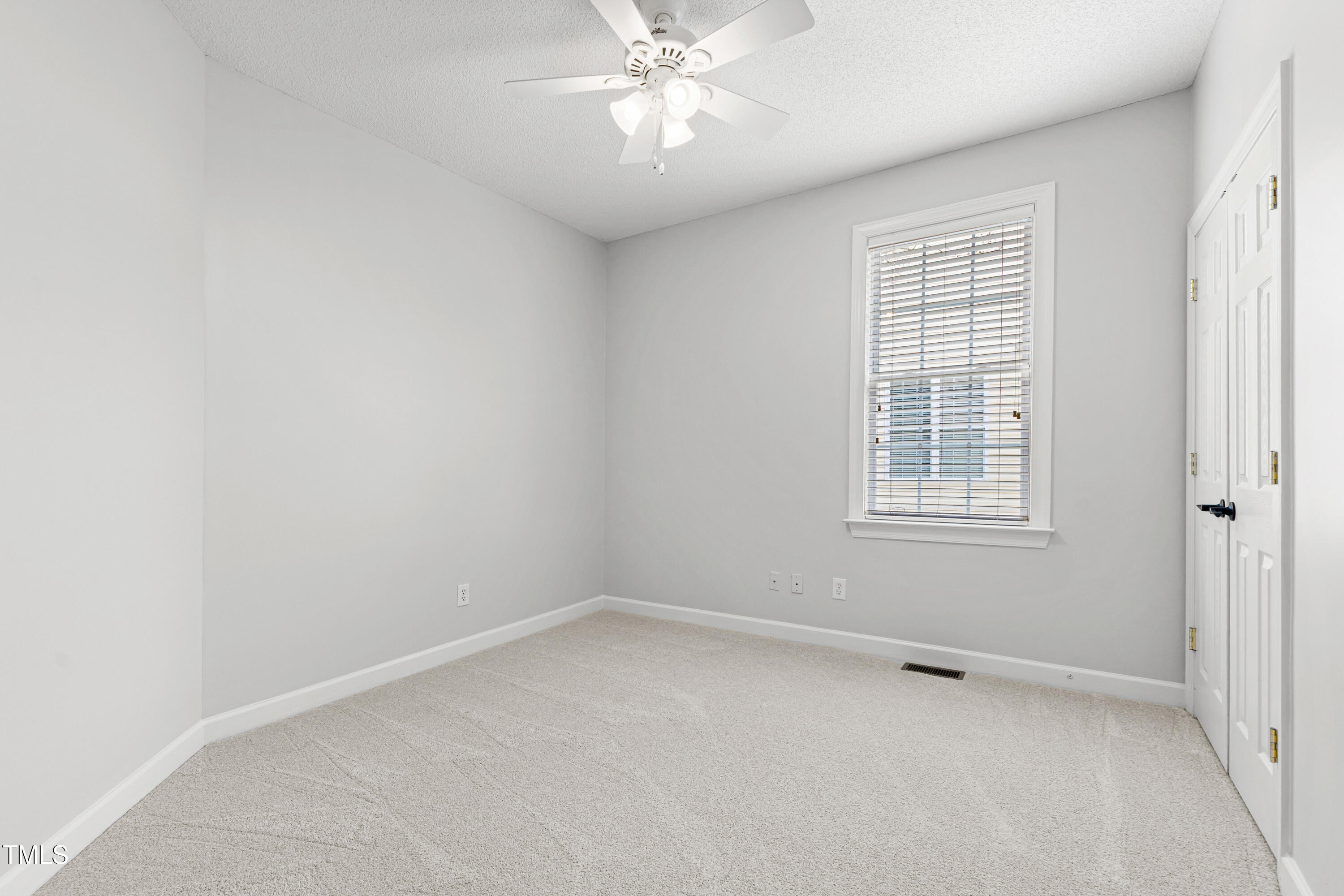 2024 Heritage Pines Drive Cary, NC 27519 - Photo 25 of 31 an empty room with a window and a fan