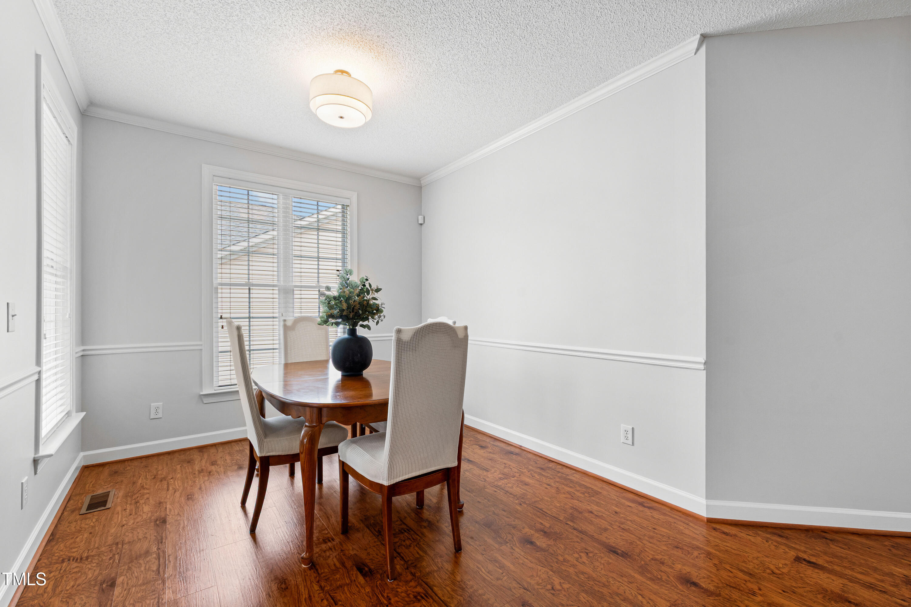 2024 Heritage Pines Drive Cary, NC 27519 - Photo 7 of 31 a view of a dining room with furniture and wooden floor