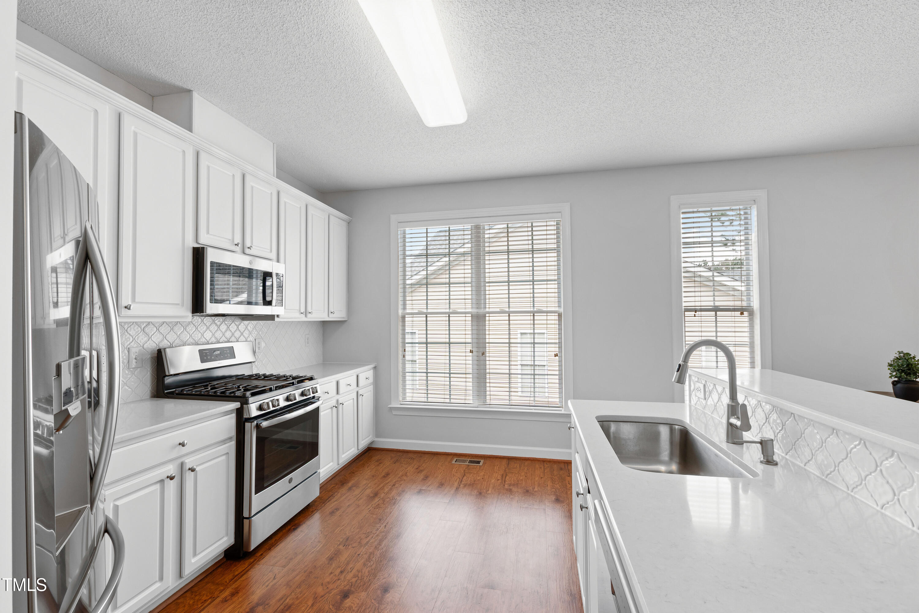 2024 Heritage Pines Drive Cary, NC 27519 - Photo 10 of 31 a kitchen with stainless steel appliances granite countertop a sink stove and refrigerator