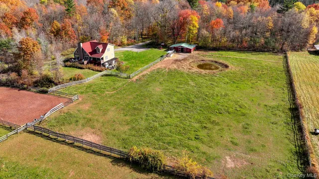 a view of a tennis ground with large trees