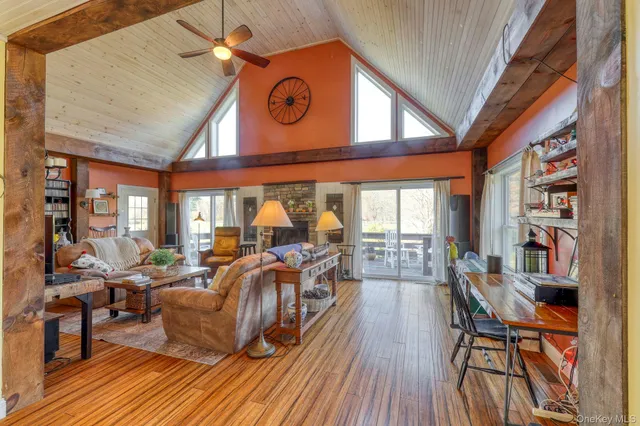 a view of a dining room with furniture a chandelier and wooden floor