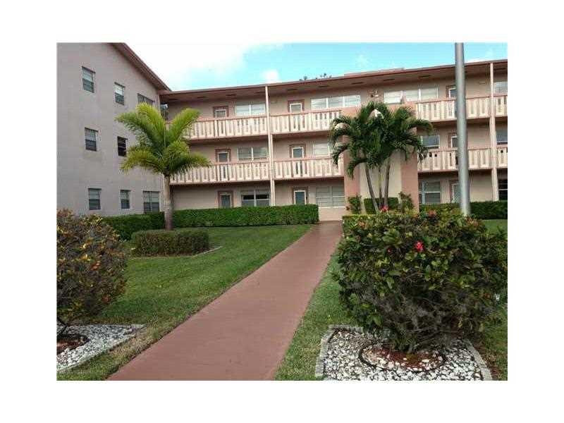 319 Mansfield H, Unit 319 Boca Raton, FL 33434 - Photo 1 of 6 a view of a building with a garden