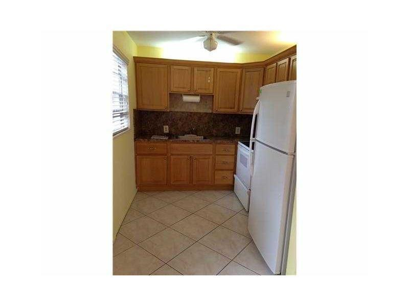 319 Mansfield H, Unit 319 Boca Raton, FL 33434 - Photo 2 of 6 a bathroom with a sink and a washer