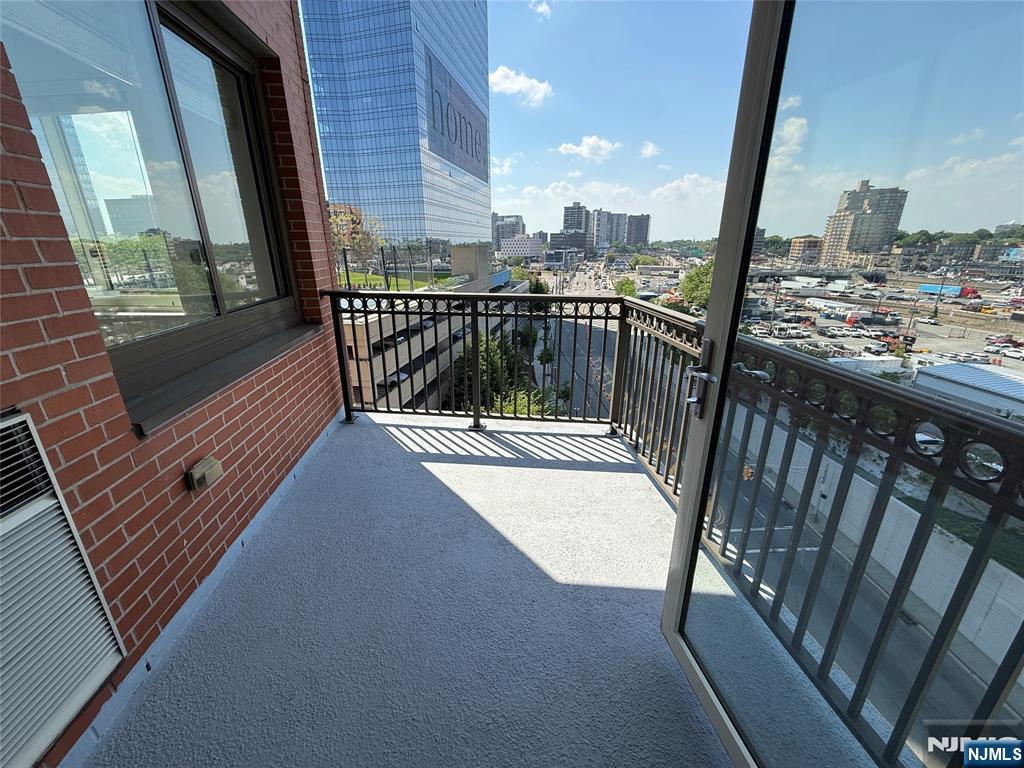 2050 North Central Road, Unit 710 Fort Lee, NJ 07024 - Photo 11 of 21 a balcony with view of car parked