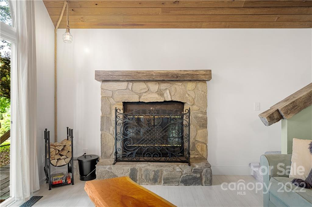 37 Country Road Clyde, NC 28721 - Photo 17 of 46 a living room with furniture and a fireplace