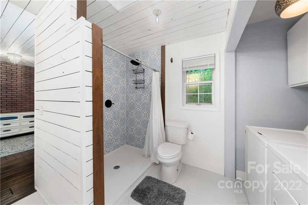 37 Country Road Clyde, NC 28721 - Photo 34 of 46 a bathroom with a toilet a sink and shower
