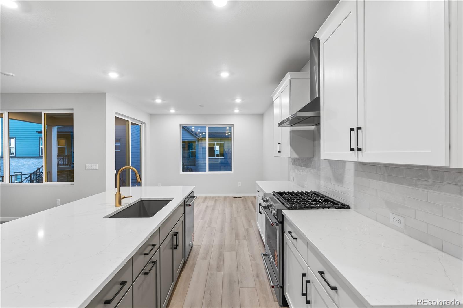 12051 Amplify Circle Lone Tree, CO 80134 - Photo 14 of 34 a kitchen with stainless steel appliances granite countertop a sink stove and cabinets