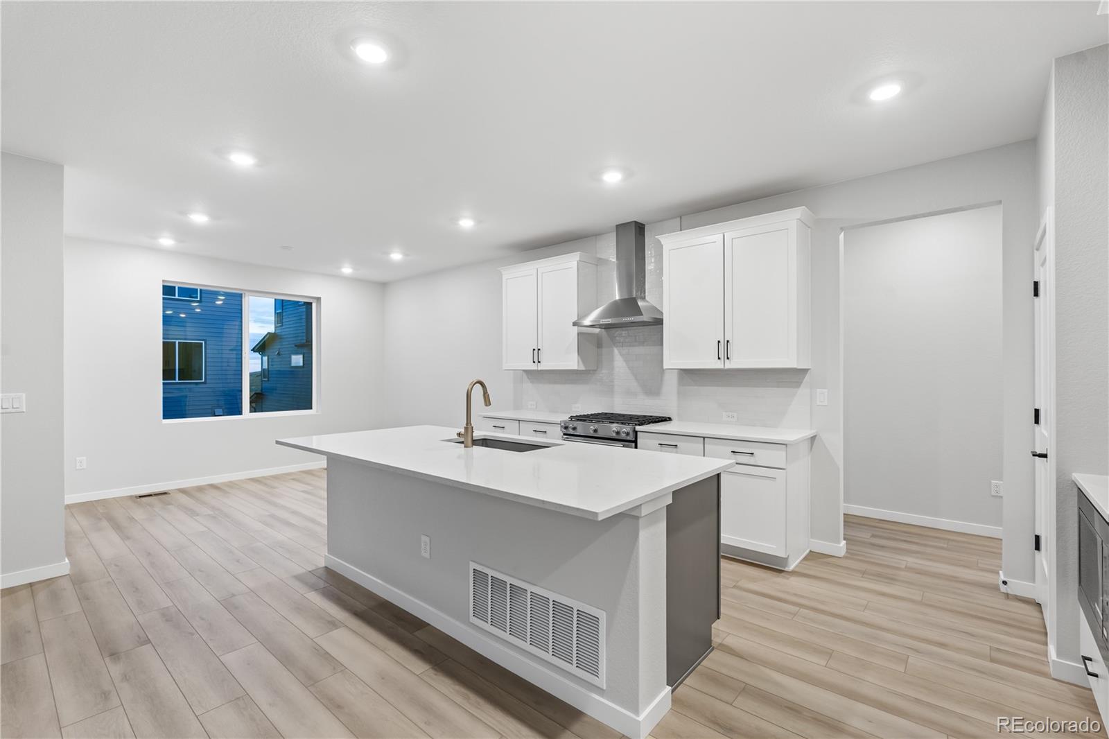 12051 Amplify Circle Lone Tree, CO 80134 - Photo 15 of 34 a kitchen with stainless steel appliances granite countertop a sink stove and refrigerator