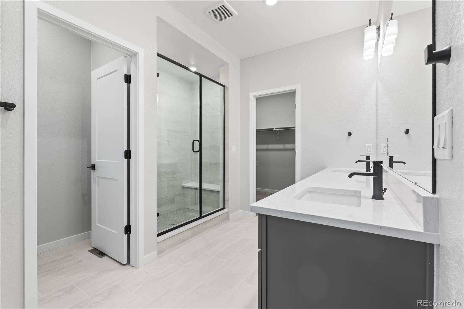 12051 Amplify Circle Lone Tree, CO 80134 - Photo 18 of 34 a bathroom with a sink shower and a mirror