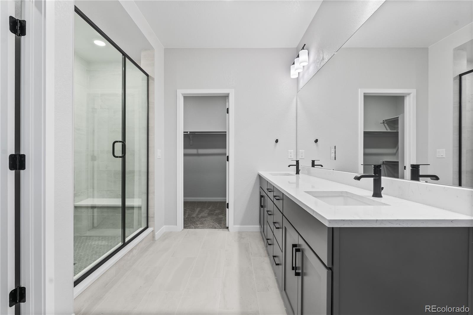 12051 Amplify Circle Lone Tree, CO 80134 - Photo 19 of 34 a spacious bathroom with a double vanity sink mirror and shower