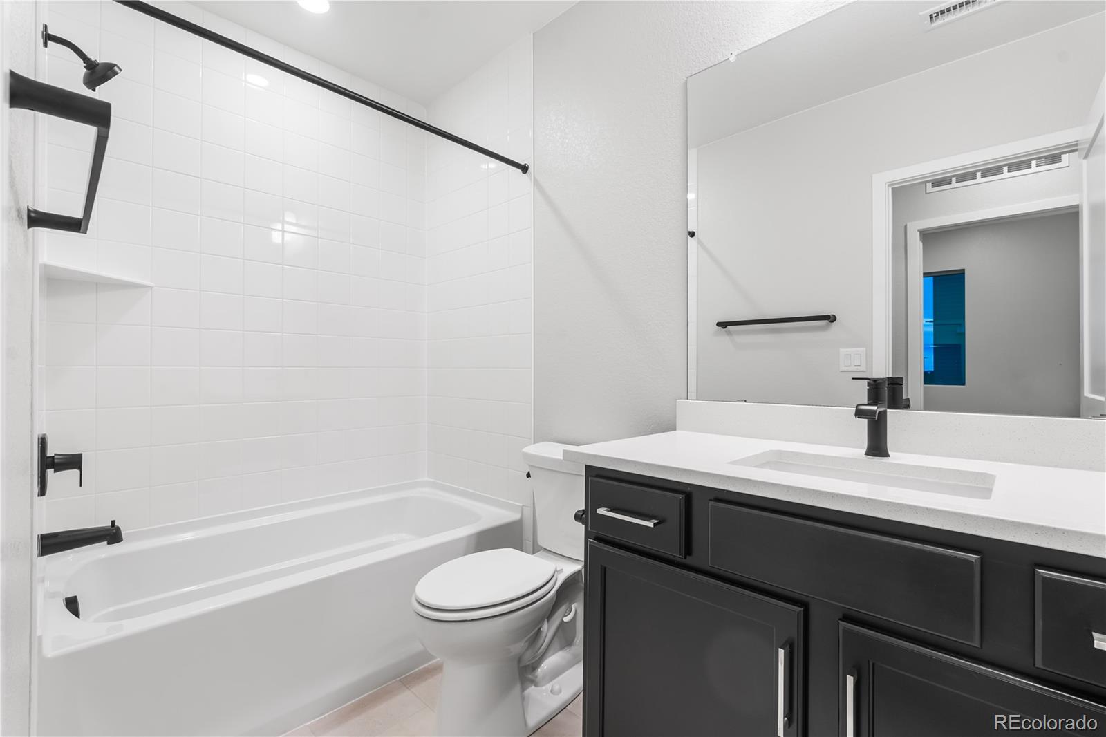 12051 Amplify Circle Lone Tree, CO 80134 - Photo 23 of 34 a bathroom with a sink a toilet and shower