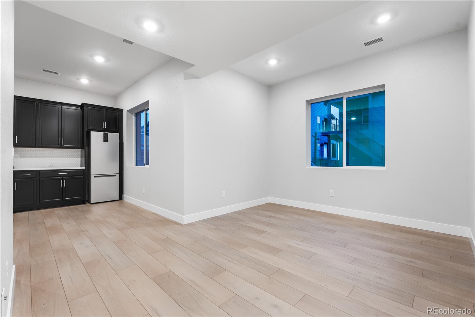 12051 Amplify Circle Lone Tree, CO 80134 - Photo 26 of 34 an empty room with wooden floor and windows