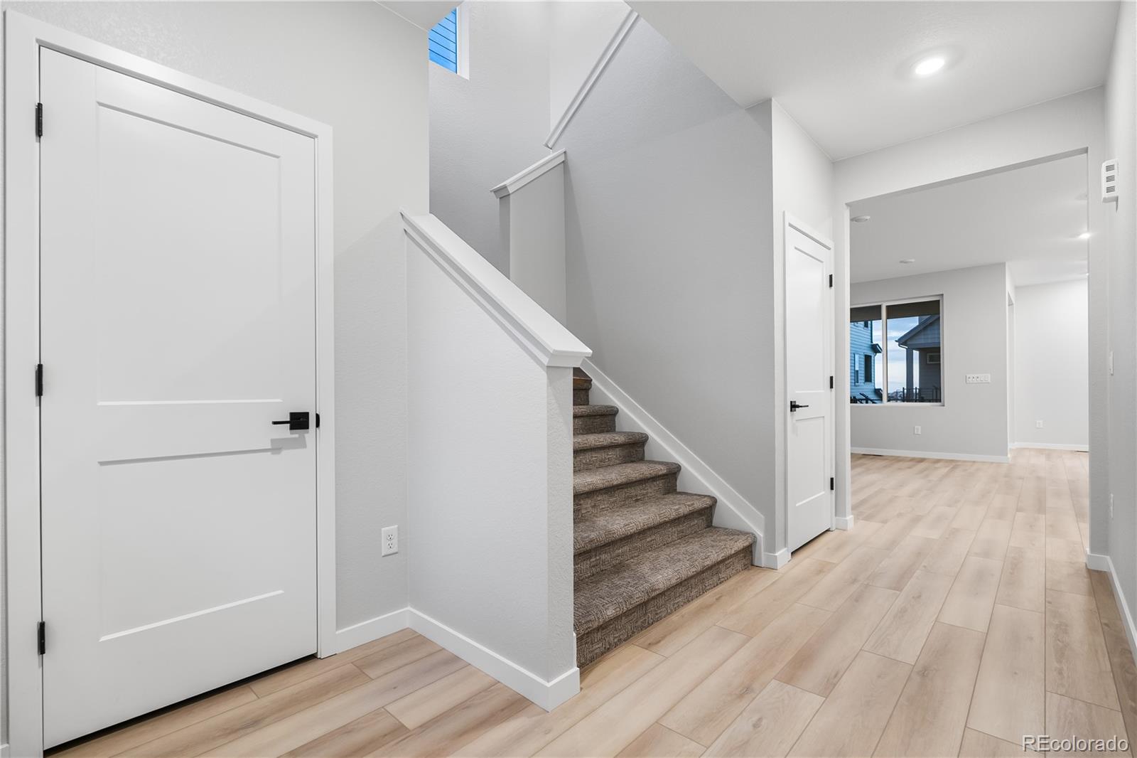 12051 Amplify Circle Lone Tree, CO 80134 - Photo 6 of 34 a view of a hallway with wooden floor and entryway