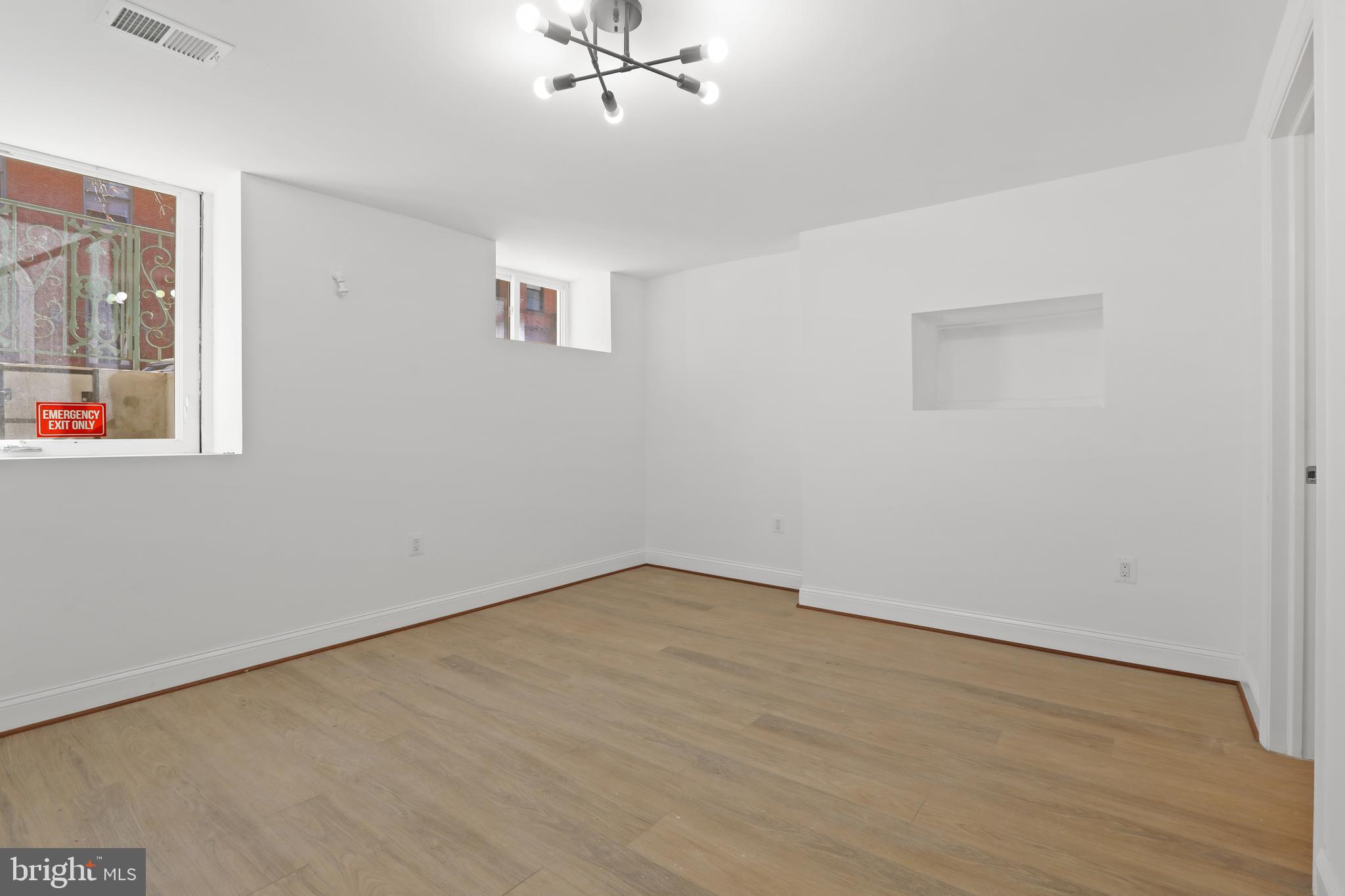 812 Park Avenue, Unit LL Baltimore, MD 21201 - Photo 11 of 16 an empty room with a window and ceiling fan