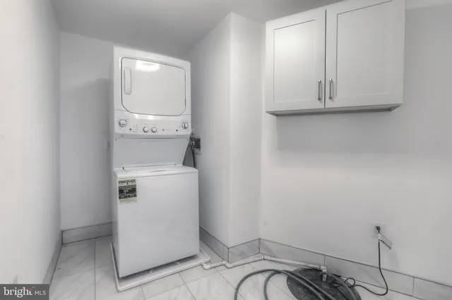 a view of a storage and utility room with washer and dryer