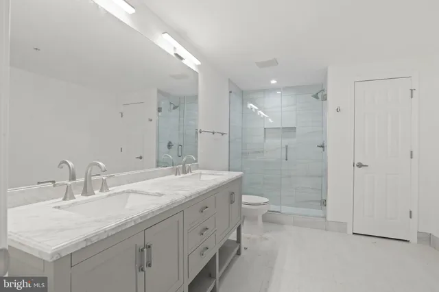 a bathroom with a double vanity sink mirror double and shower