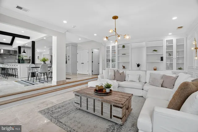a living room with furniture and kitchen view