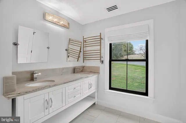 a living room with a fireplace and a floor to ceiling window
