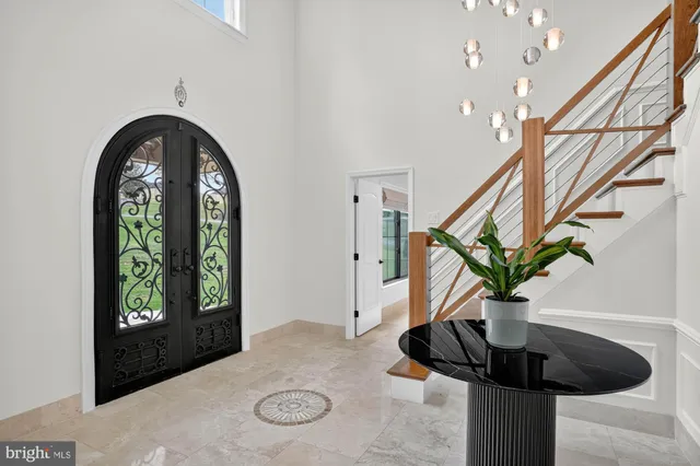 a kitchen with stainless steel appliances kitchen island granite countertop a table and chairs in it