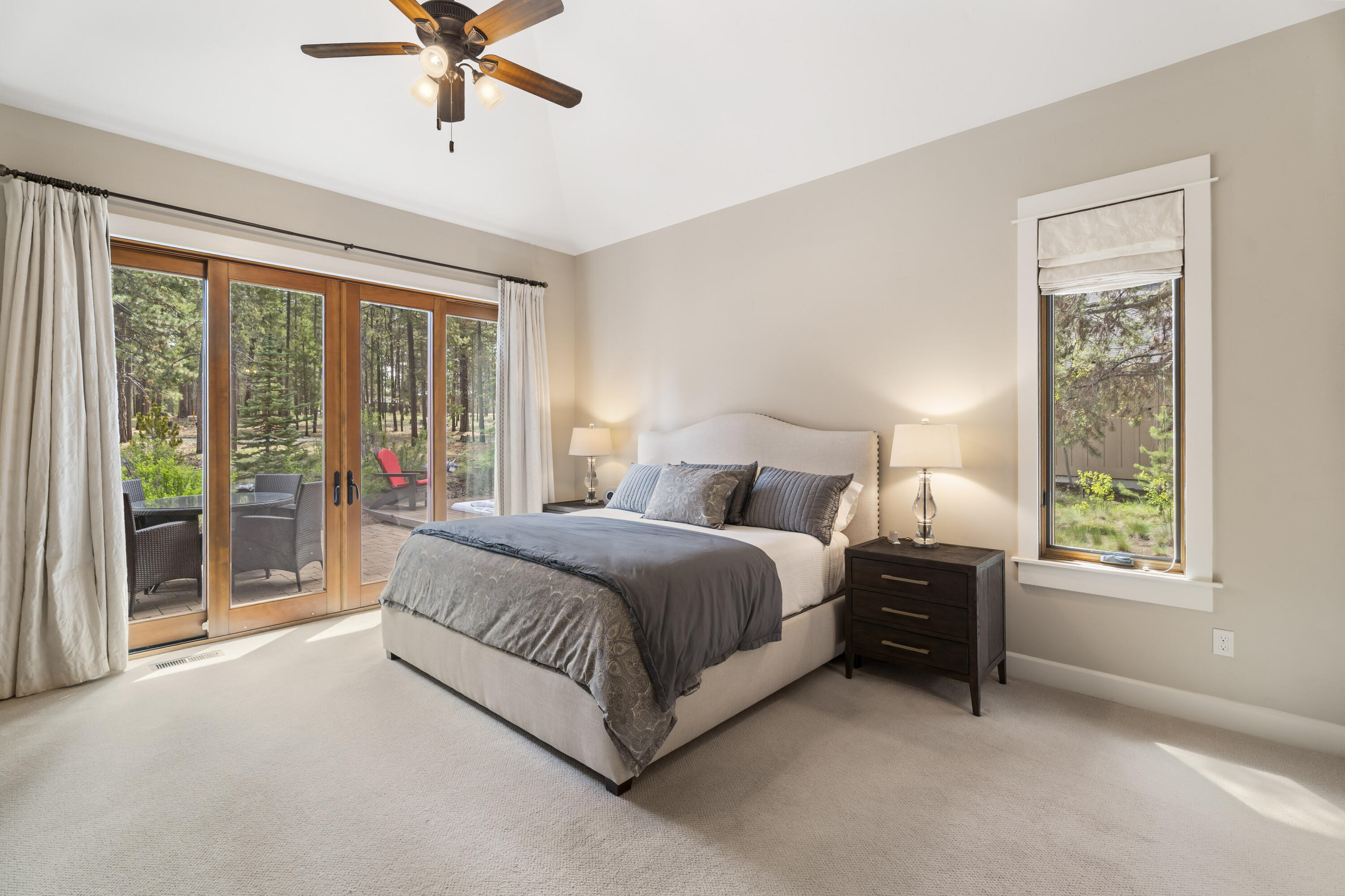 56155 Sable Rock Loop, Unit 277 Bend, OR 97707 - Photo 22 of 63 The spacious main-level primary suite offers vaulted ceilings, tranquil forest views, and direct access to the private patio w/ hot tub.