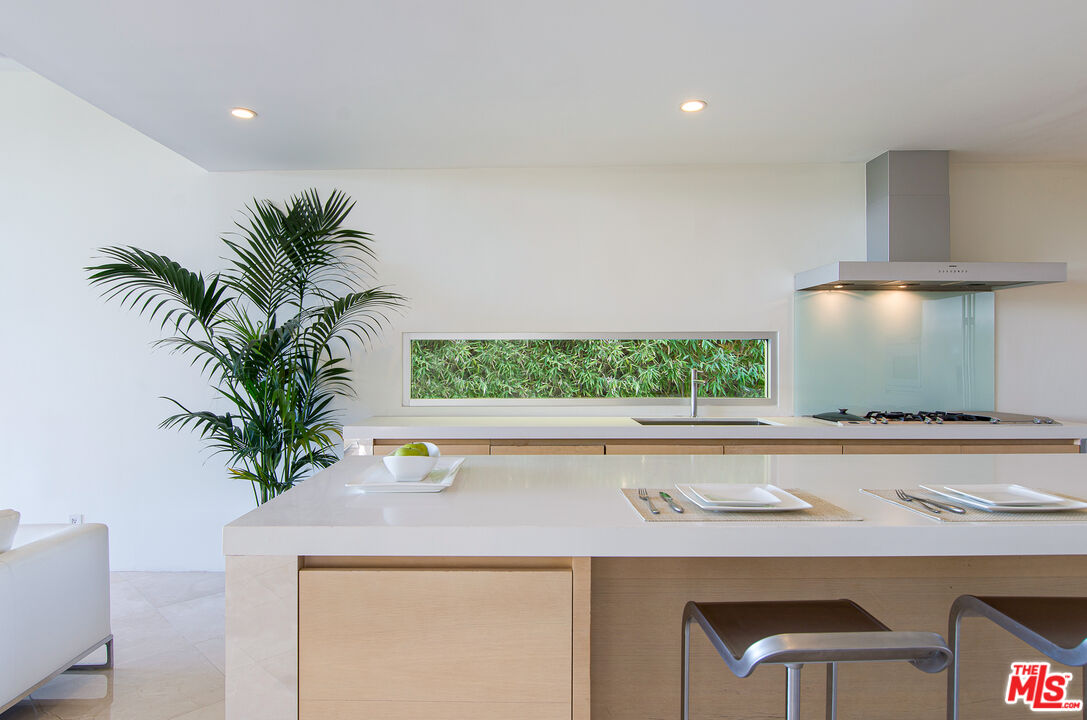 1466 Bel Air Road Los Angeles, CA 90077 - Photo 19 of 35 a close view of dining table chair with potted plant