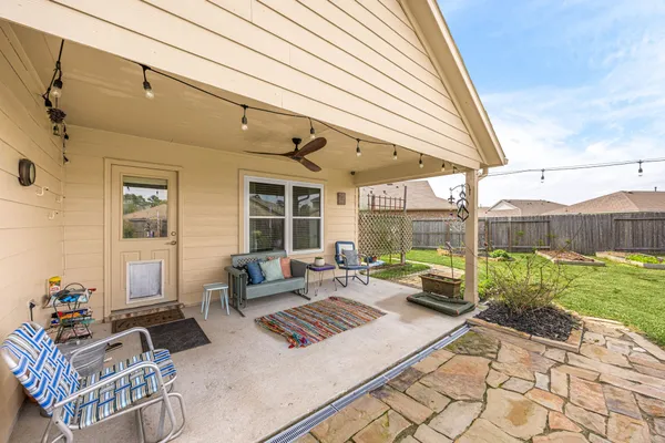 a building outdoor space with patio furniture and garden