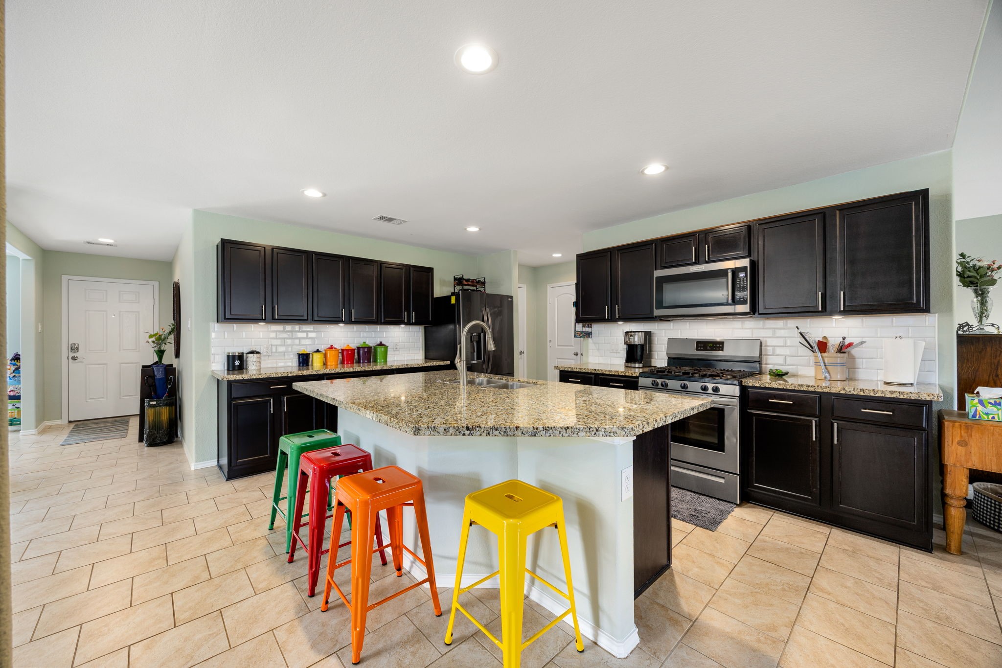 2627 Ski Lodge Drive Spring, TX 77373 - Photo 6 of 30 a kitchen with stainless steel appliances granite countertop a stove top oven a sink dishwasher a dining table and chairs with wooden floor