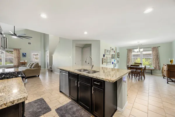 a living room with granite countertop furniture a dining table and chairs