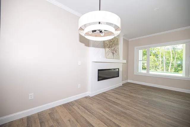 an empty room with a fireplace and a window