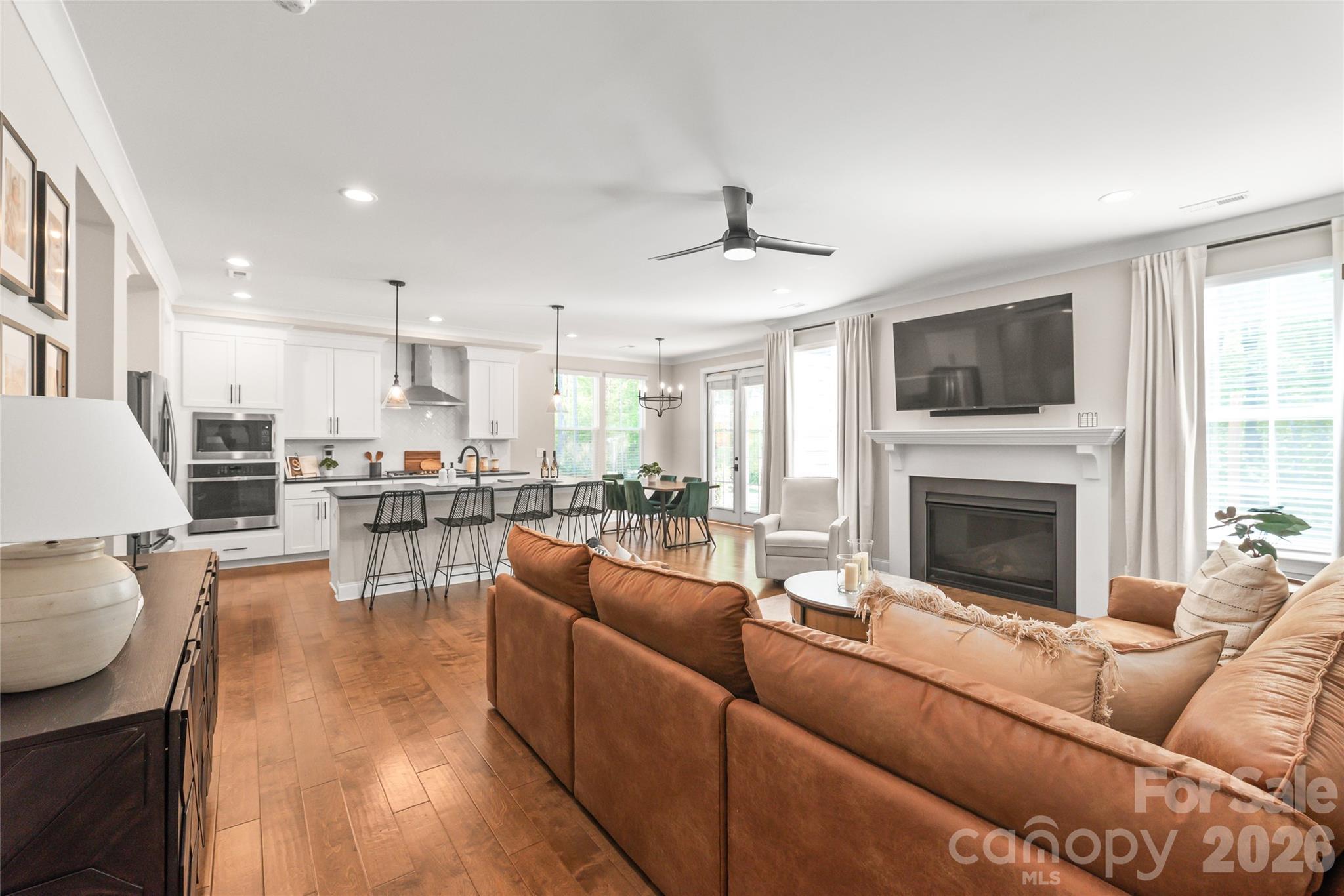 3213 Timber Run Lane Maiden, NC 28650 - Photo 24 of 47 a living room with furniture a fireplace and a flat screen tv