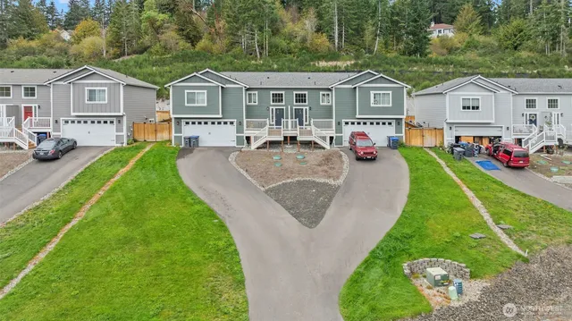 a view of house with a garden and pathway