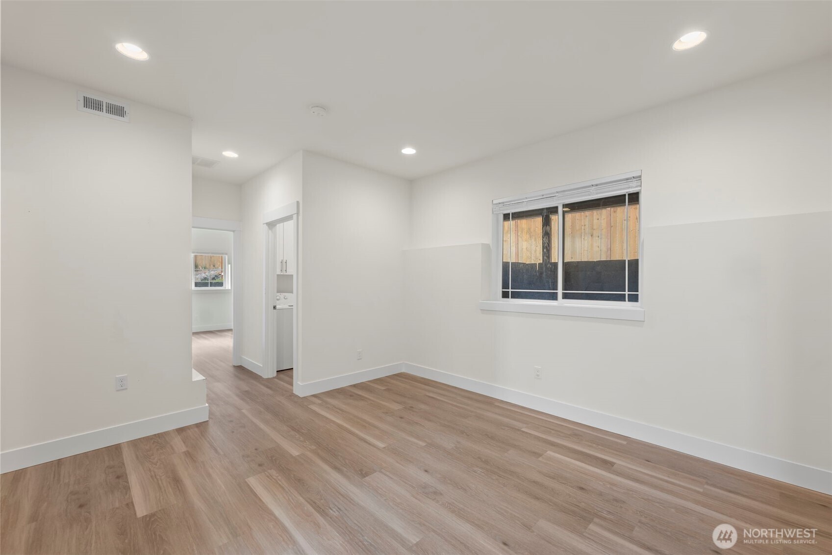 19015 Highway 3, Unit AB Allyn, WA 98524 - Photo 4 of 31 wooden floor in an empty room with a window