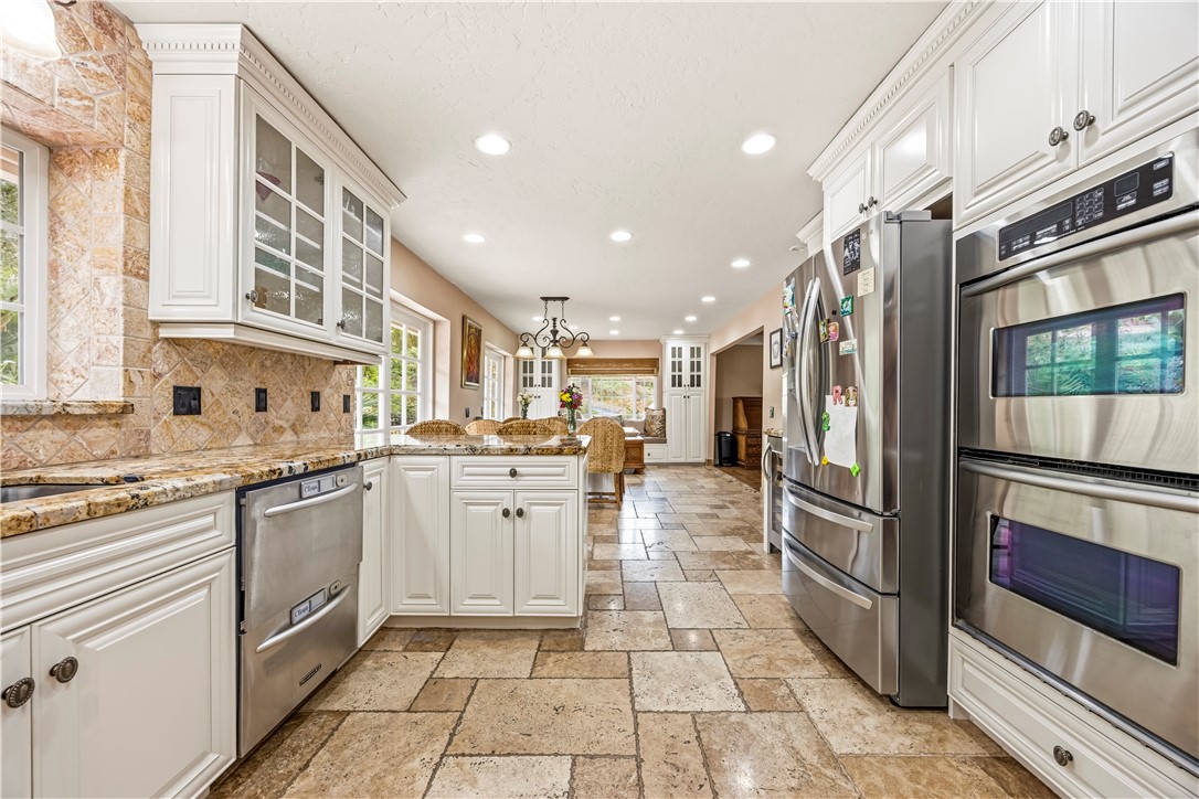 1485 Vía Ladera Fallbrook, CA 92028 - Photo 14 of 43 a kitchen with stainless steel appliances granite countertop a refrigerator and a stove top oven