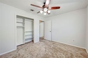 12415 Nova Drive Houston, TX 77077 - Photo 12 of 16 an empty room with closet and fan