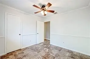 a view of a room with a ceiling fan and a window